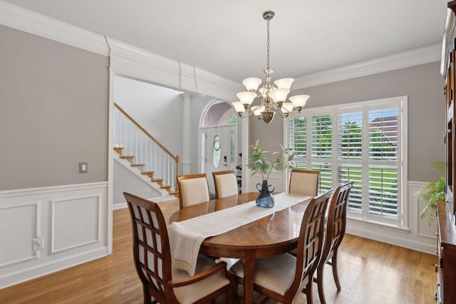 1926 Cliffview Ct, Murfreesboro, TN 37128 - dining area with a chandelier, wainscoting, light wood-style floors, a decorative wall, and ornamental molding