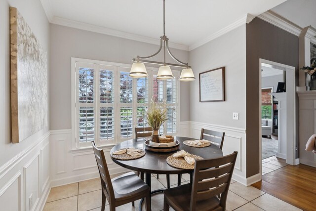 1926 Cliffview Ct, Murfreesboro, TN 37128 - dining space with healthy amount of natural light, a wainscoted wall, crown molding, a decorative wall, and light tile patterned flooring