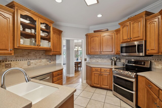1926 Cliffview Ct, Murfreesboro, TN 37128 - kitchen with appliances with stainless steel finishes, a sink, glass insert cabinets, light tile patterned flooring, and light countertops
