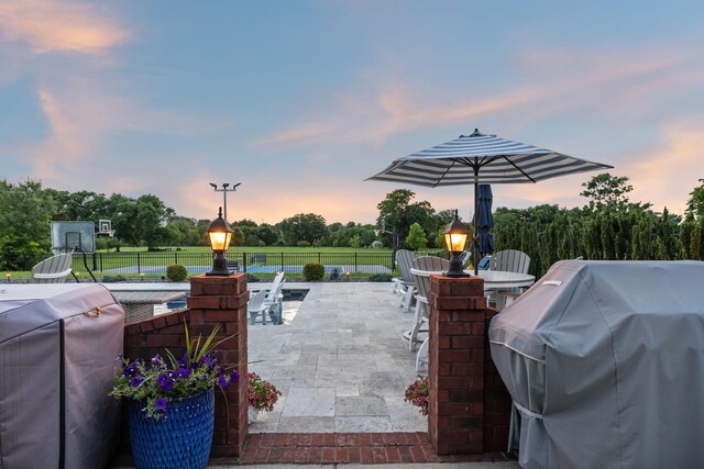 1926 Cliffview Ct, Murfreesboro, TN 37128 - patio terrace at dusk featuring grilling area, outdoor dining space, a fenced backyard, and a patio