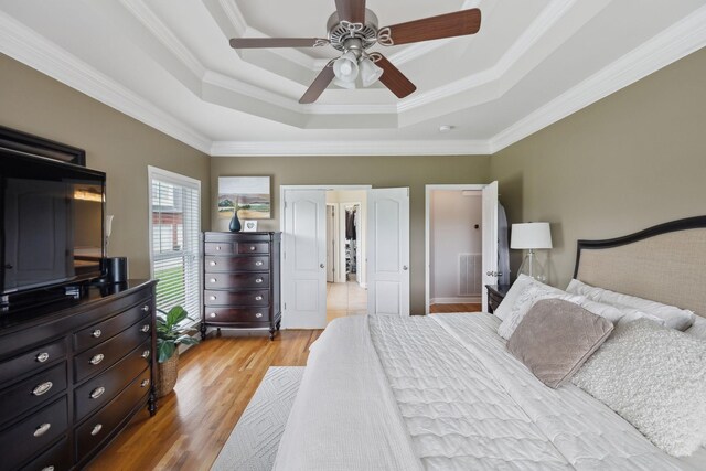1926 Cliffview Ct, Murfreesboro, TN 37128 - bedroom with a tray ceiling, light wood-type flooring, ornamental molding, and a ceiling fan