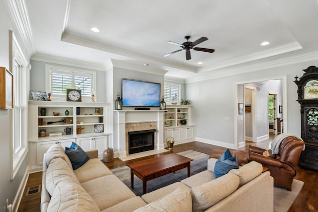 1577 Westhaven Blvd, Franklin, TN 37064 - living room featuring a fireplace with flush hearth, a tray ceiling, ceiling fan, wood finished floors, and crown molding