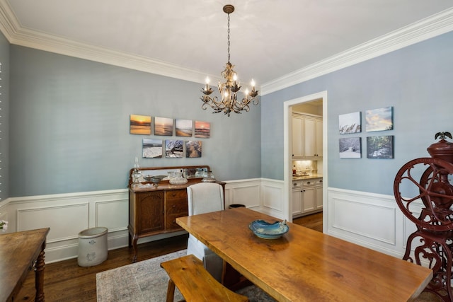 1577 Westhaven Blvd, Franklin, TN 37064 - dining space featuring ornamental molding, a chandelier, a wainscoted wall, dark wood finished floors, and a decorative wall