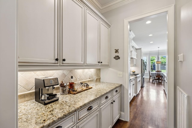 1577 Westhaven Blvd, Franklin, TN 37064 - kitchen with freestanding refrigerator, crown molding, decorative backsplash, light stone counters, and dark wood-style floors