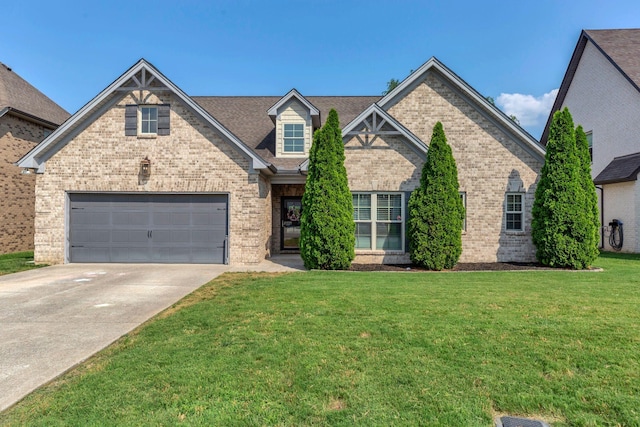 1240 Hensfield Dr, Murfreesboro, TN 37128 - view of front of property featuring brick siding, driveway, a front yard, and a garage