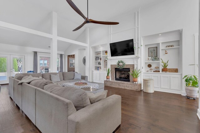 1240 Hensfield Dr, Murfreesboro, TN 37128 - living area featuring high vaulted ceiling, ceiling fan, built in shelves, a brick fireplace, and dark wood-type flooring