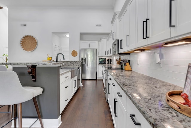 1240 Hensfield Dr, Murfreesboro, TN 37128 - kitchen featuring appliances with stainless steel finishes, a breakfast bar, a sink, and light stone counters
