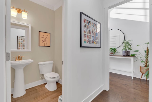 1240 Hensfield Dr, Murfreesboro, TN 37128 - half bath featuring wood finished floors, toilet, baseboards, and a sink