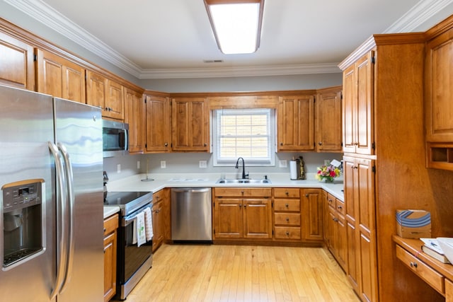 362 Chase Cir, Winchester, TN 37398 - kitchen with stainless steel appliances, a sink, brown cabinetry, light wood-type flooring, and light countertops