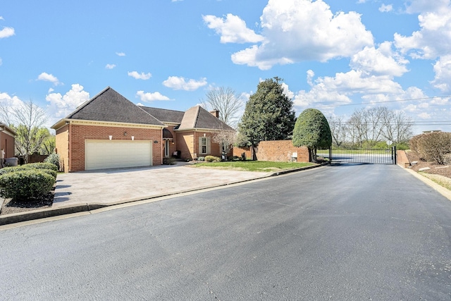 100 Carriage Way, Hendersonville, TN 37075 - view of front of property featuring driveway, a garage, a gate, and brick siding