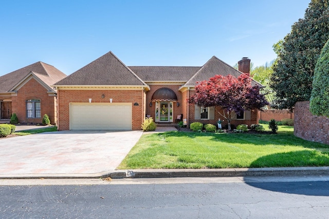 100 Carriage Way, Hendersonville, TN 37075 - view of front of property featuring a garage, a chimney, a front yard, driveway, and brick siding
