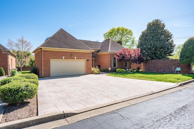 100 Carriage Way, Hendersonville, TN 37075 - view of front facade with a garage, decorative driveway, brick siding, and a shingled roof