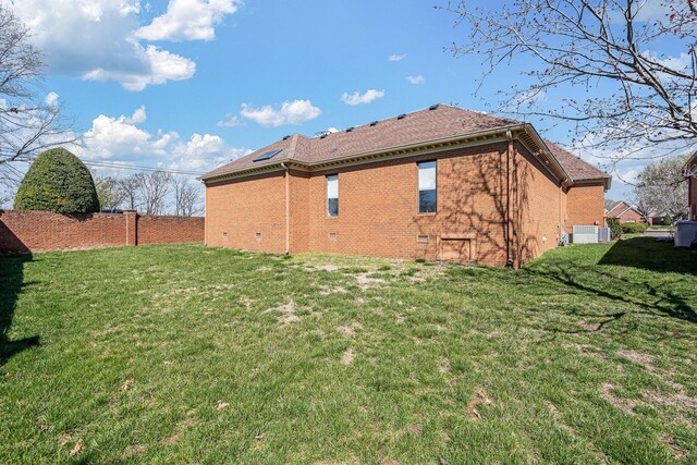 100 Carriage Way, Hendersonville, TN 37075 - rear view of property with a lawn, brick siding, roof mounted solar panels, and cooling unit