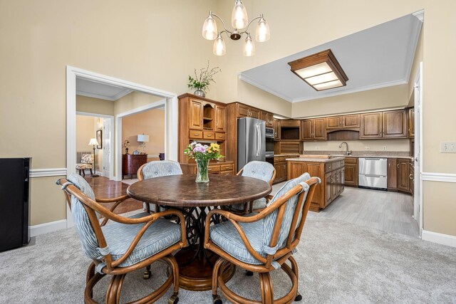 100 Carriage Way, Hendersonville, TN 37075 - dining area with a chandelier, light colored carpet, ornamental molding, baseboards, and a high ceiling