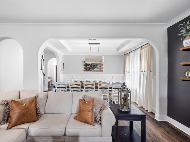 3005 Langston Pl, Spring Hill, TN 37174 - living room with dark wood-style floors, arched walkways, a raised ceiling, and ornamental molding