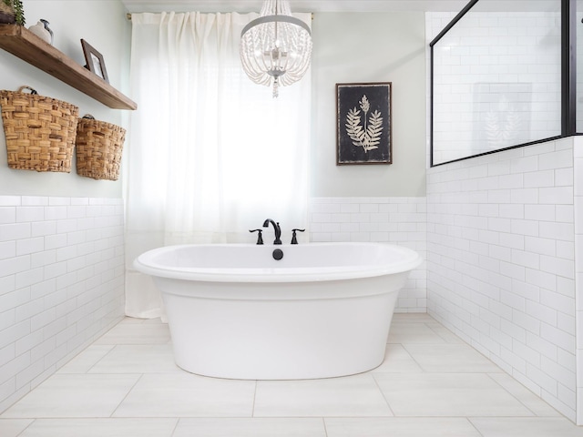 3005 Langston Pl, Spring Hill, TN 37174 - full bath featuring tile walls, a wainscoted wall, a freestanding bath, a chandelier, and tile patterned floors