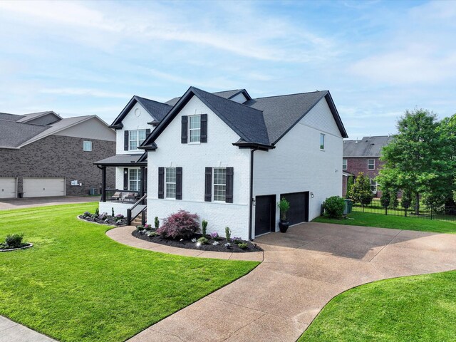 3005 Langston Pl, Spring Hill, TN 37174 - traditional home with a garage, brick siding, and driveway
