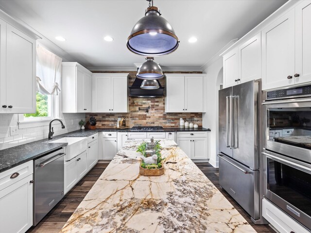 3005 Langston Pl, Spring Hill, TN 37174 - kitchen with stainless steel appliances, tasteful backsplash, white cabinets, dark stone countertops, and crown molding