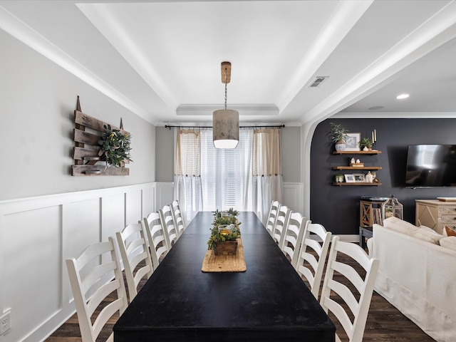 3005 Langston Pl, Spring Hill, TN 37174 - dining space featuring a raised ceiling, a decorative wall, crown molding, dark wood finished floors, and wainscoting