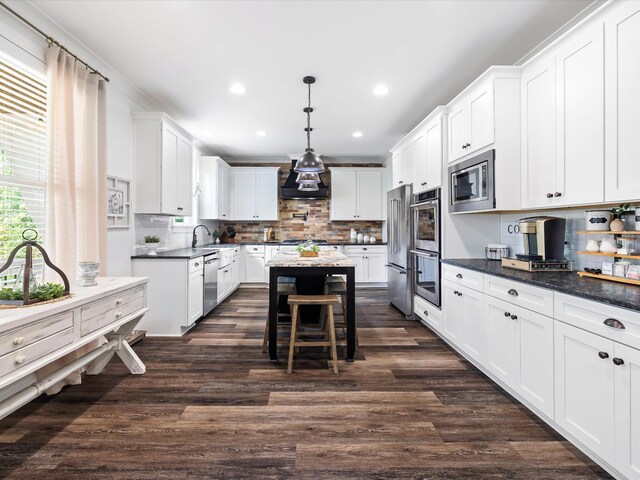 3005 Langston Pl, Spring Hill, TN 37174 - kitchen with appliances with stainless steel finishes, a center island, recessed lighting, backsplash, and white cabinets
