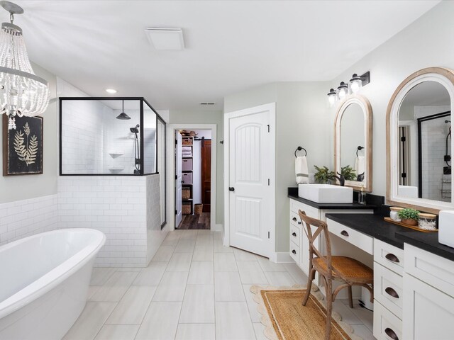 3005 Langston Pl, Spring Hill, TN 37174 - bathroom with a stall shower, vanity, a freestanding bath, tile patterned flooring, and a chandelier