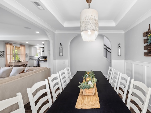 3005 Langston Pl, Spring Hill, TN 37174 - dining room featuring arched walkways, a raised ceiling, wainscoting, crown molding, and recessed lighting