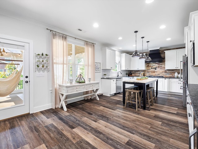 3005 Langston Pl, Spring Hill, TN 37174 - kitchen featuring stainless steel appliances, premium range hood, dark wood finished floors, a kitchen island, and backsplash