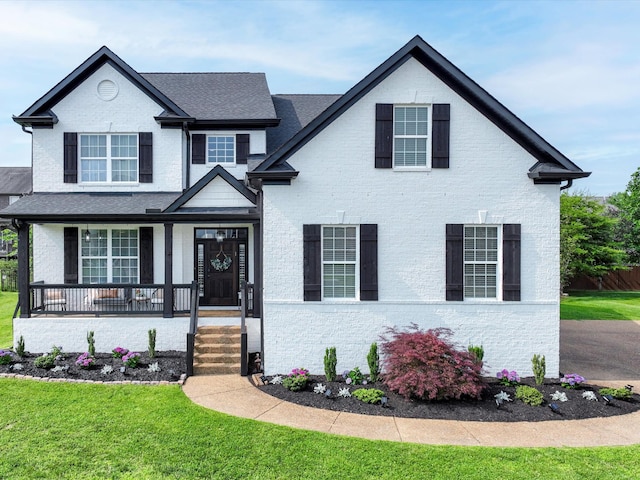 3005 Langston Pl, Spring Hill, TN 37174 - view of front of property featuring brick siding, a front yard, and covered porch