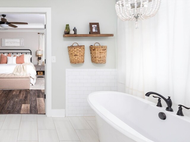 3005 Langston Pl, Spring Hill, TN 37174 - ensuite bathroom with a soaking tub, a ceiling fan, a chandelier, and tile patterned flooring