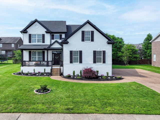 3005 Langston Pl, Spring Hill, TN 37174 - traditional-style house with a porch, brick siding, driveway, and a shingled roof