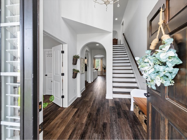 3005 Langston Pl, Spring Hill, TN 37174 - entryway featuring arched walkways, dark wood-style floors, stairway, a towering ceiling, and baseboards
