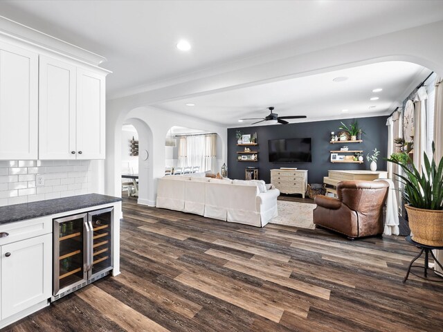 3005 Langston Pl, Spring Hill, TN 37174 - living room with arched walkways, beverage cooler, dark wood-style floors, ceiling fan, and recessed lighting