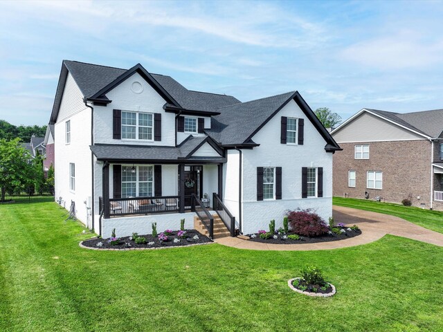 3005 Langston Pl, Spring Hill, TN 37174 - traditional-style house featuring covered porch and a front yard