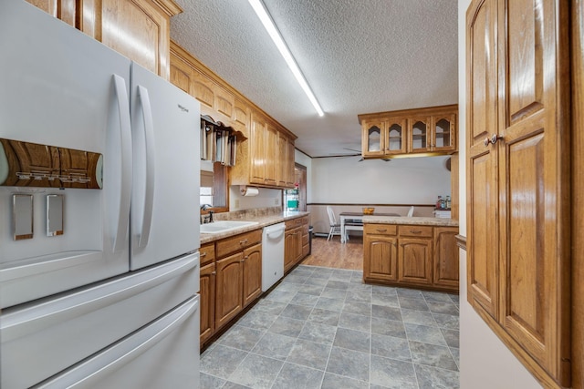 239 Henry Bayless Rd, Ardmore, TN 38449 - kitchen with white appliances, a sink, light countertops, brown cabinets, and a textured ceiling