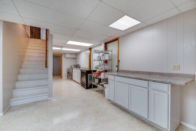 239 Henry Bayless Rd, Ardmore, TN 38449 - finished basement featuring stairway, a paneled ceiling, and baseboards