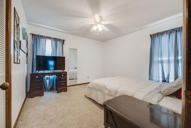 239 Henry Bayless Rd, Ardmore, TN 38449 - bedroom with carpet, baseboards, a textured ceiling, and a ceiling fan