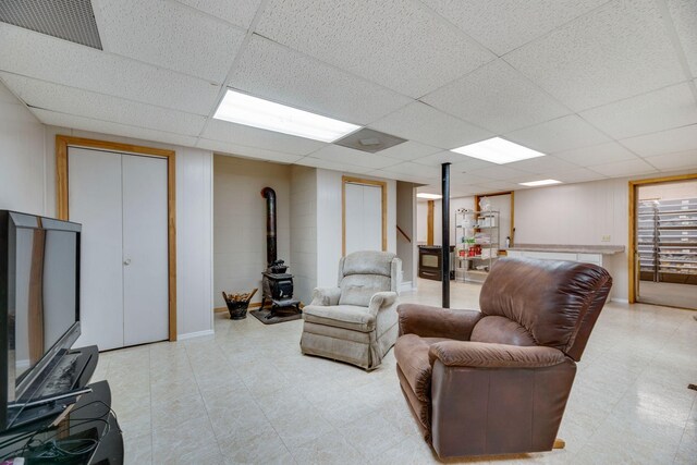 239 Henry Bayless Rd, Ardmore, TN 38449 - living area with a wood stove, a paneled ceiling, and light floors