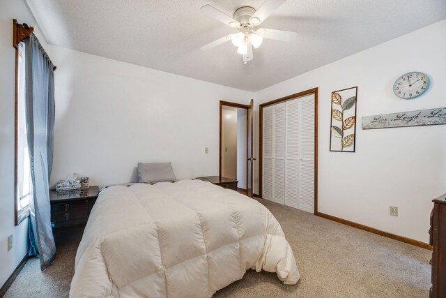 239 Henry Bayless Rd, Ardmore, TN 38449 - carpeted bedroom with a closet, a ceiling fan, baseboards, and a textured ceiling