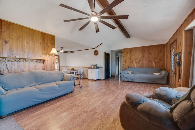 239 Henry Bayless Rd, Ardmore, TN 38449 - living room featuring wood walls, a ceiling fan, and light wood-type flooring