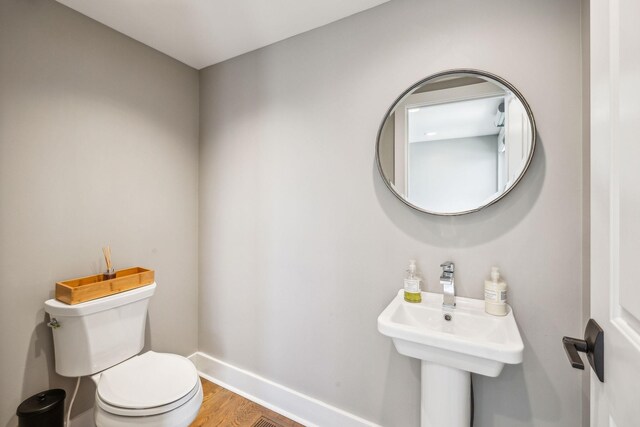 954 Russell St, Nashville, TN 37206 - bathroom with toilet, baseboards, wood finished floors, and a sink