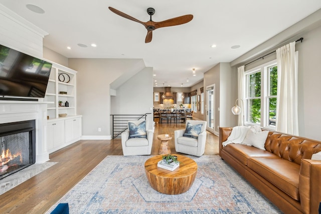 954 Russell St, Nashville, TN 37206 - living area with a ceiling fan, wood finished floors, a lit fireplace, recessed lighting, and baseboards