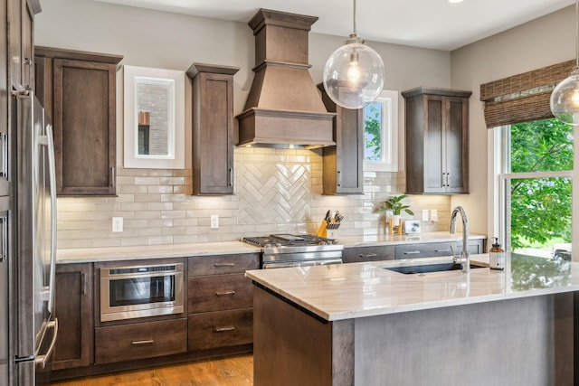 954 Russell St, Nashville, TN 37206 - kitchen featuring a sink, stainless steel appliances, custom exhaust hood, and decorative backsplash