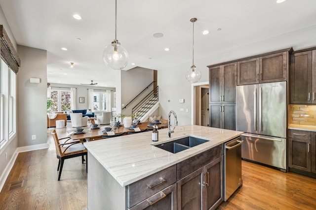 954 Russell St, Nashville, TN 37206 - kitchen featuring stainless steel appliances, a sink, recessed lighting, light wood-style flooring, and dark brown cabinets