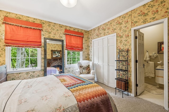 4235 Columbia Pike, Franklin, TN 37064 - carpeted bedroom featuring wallpapered walls, ornamental molding, a closet, ensuite bathroom, and a lit fireplace