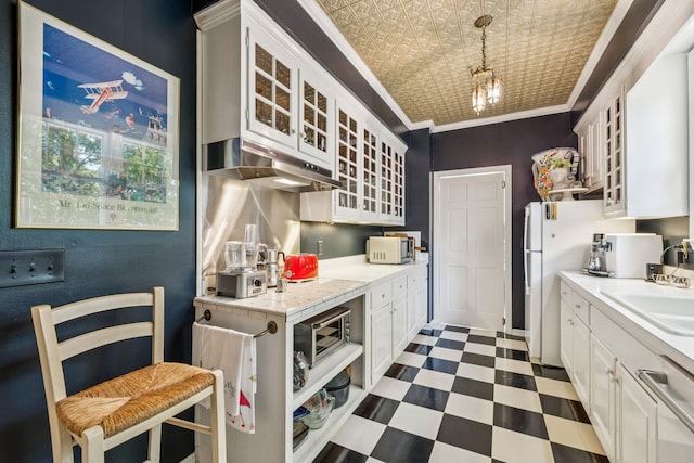 4235 Columbia Pike, Franklin, TN 37064 - kitchen featuring stainless steel microwave, under cabinet range hood, glass insert cabinets, dark flooring, and crown molding