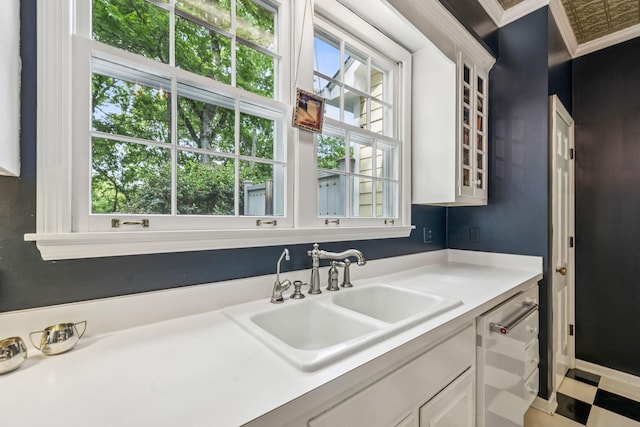 4235 Columbia Pike, Franklin, TN 37064 - kitchen with a sink, crown molding, light countertops, stainless steel dishwasher, and white cabinets