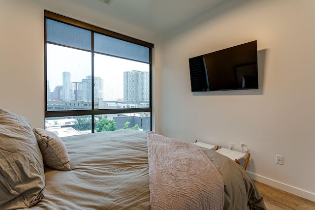 1002 Division St Unit 405, Nashville, TN 37203 - bedroom featuring baseboards and wood finished floors
