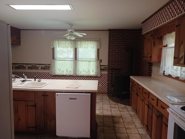 166 Westview St, Camden, TN 38320 - kitchen with white appliances, a wood stove, a sink, a ceiling fan, and light countertops