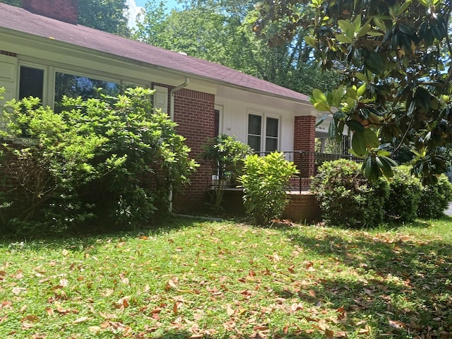 166 Westview St, Camden, TN 38320 - view of side of home featuring brick siding and a yard
