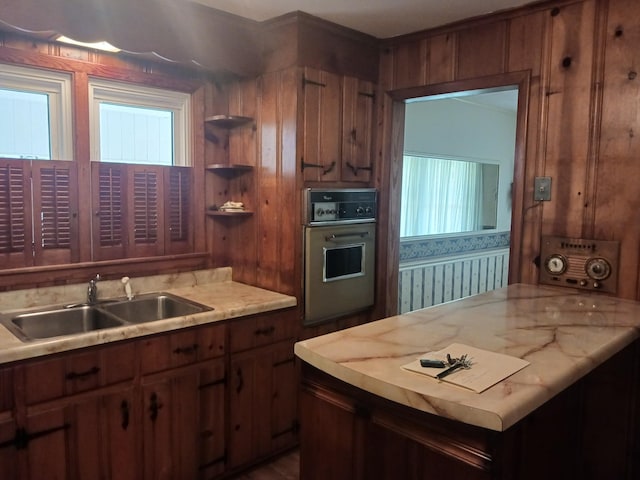 166 Westview St, Camden, TN 38320 - kitchen featuring oven, a sink, light countertops, open shelves, and brown cabinetry